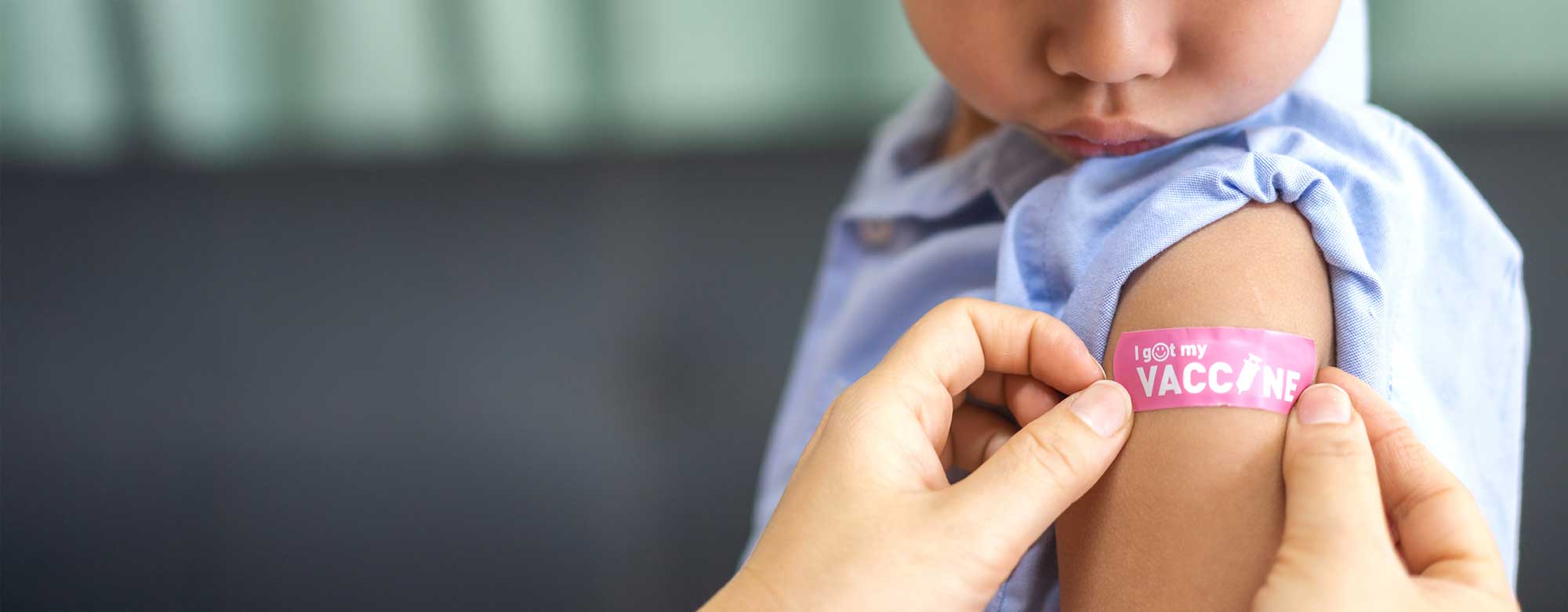 Child with bandaid after receiving immunization