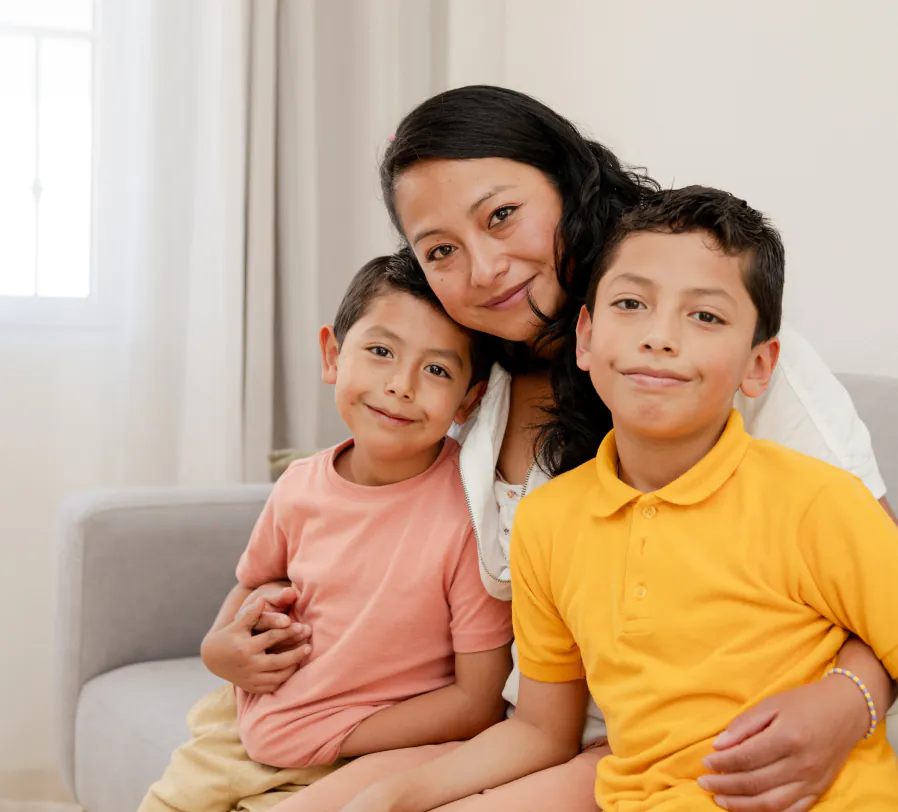 Mom with two sons smiling at camera